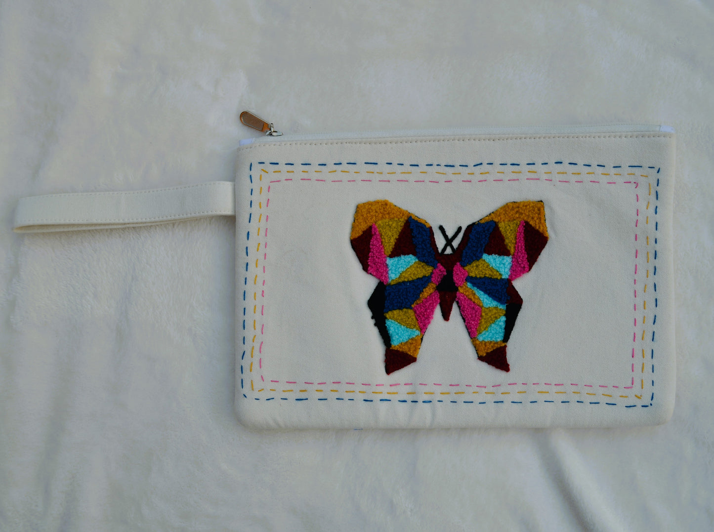 Tufted butterfly over white canvas utility bag